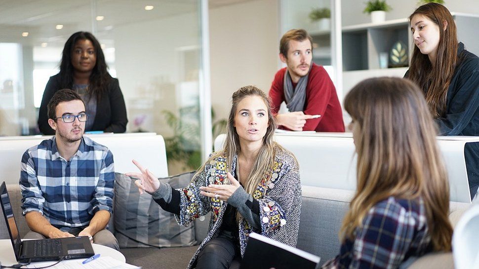 Employees sat around together discussing business issues.