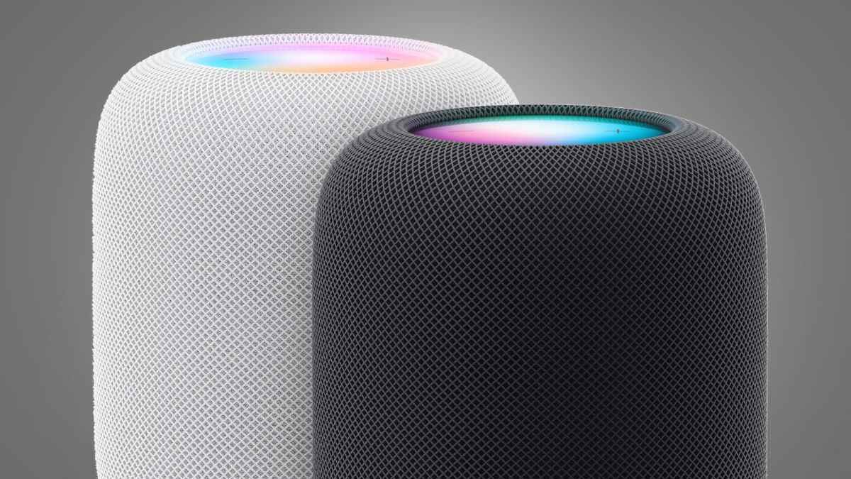 Two Apple HomePod speakers on a grey background