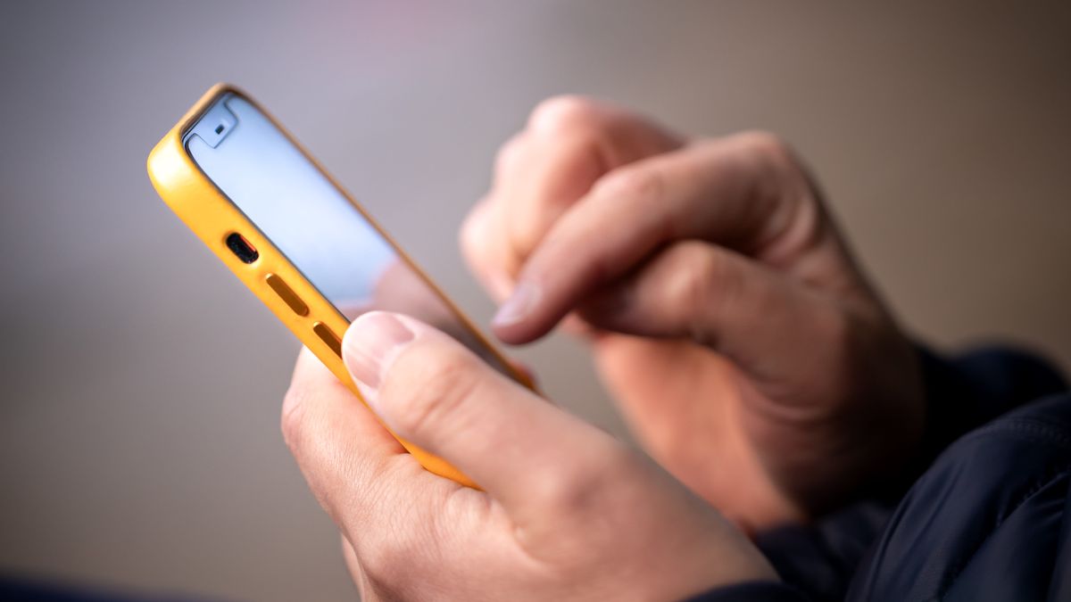 Man holding iPhone in hand