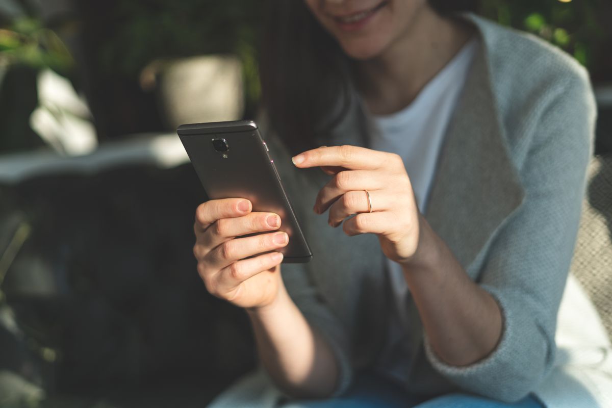 A woman using an Android phone.