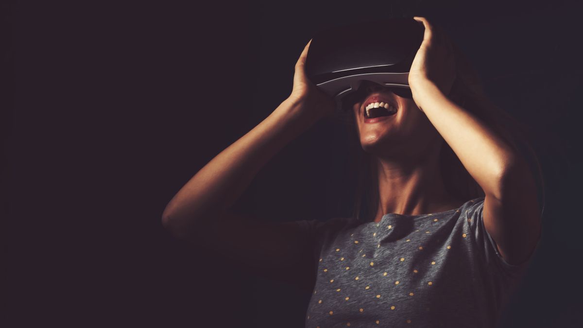 Happy young woman using a virtual reality headset